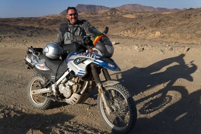 Tony Armstrong riding his motorcycle in Sudan