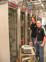 PSC Engineers Paul Cannin and Kent Horan prepare a control cubicle for testing