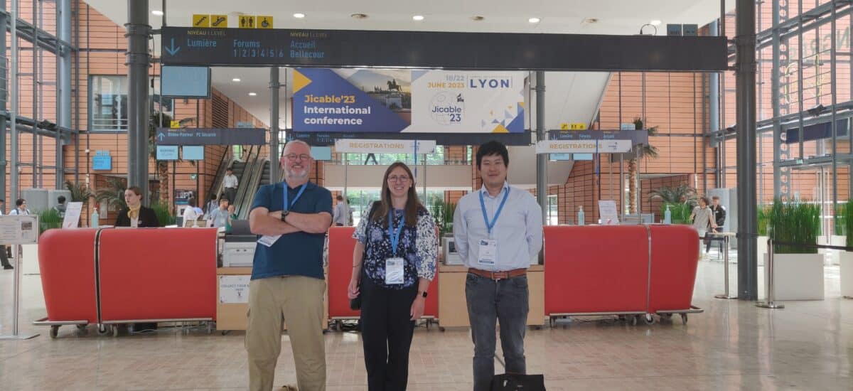 Three people posing at a tradeshow conference